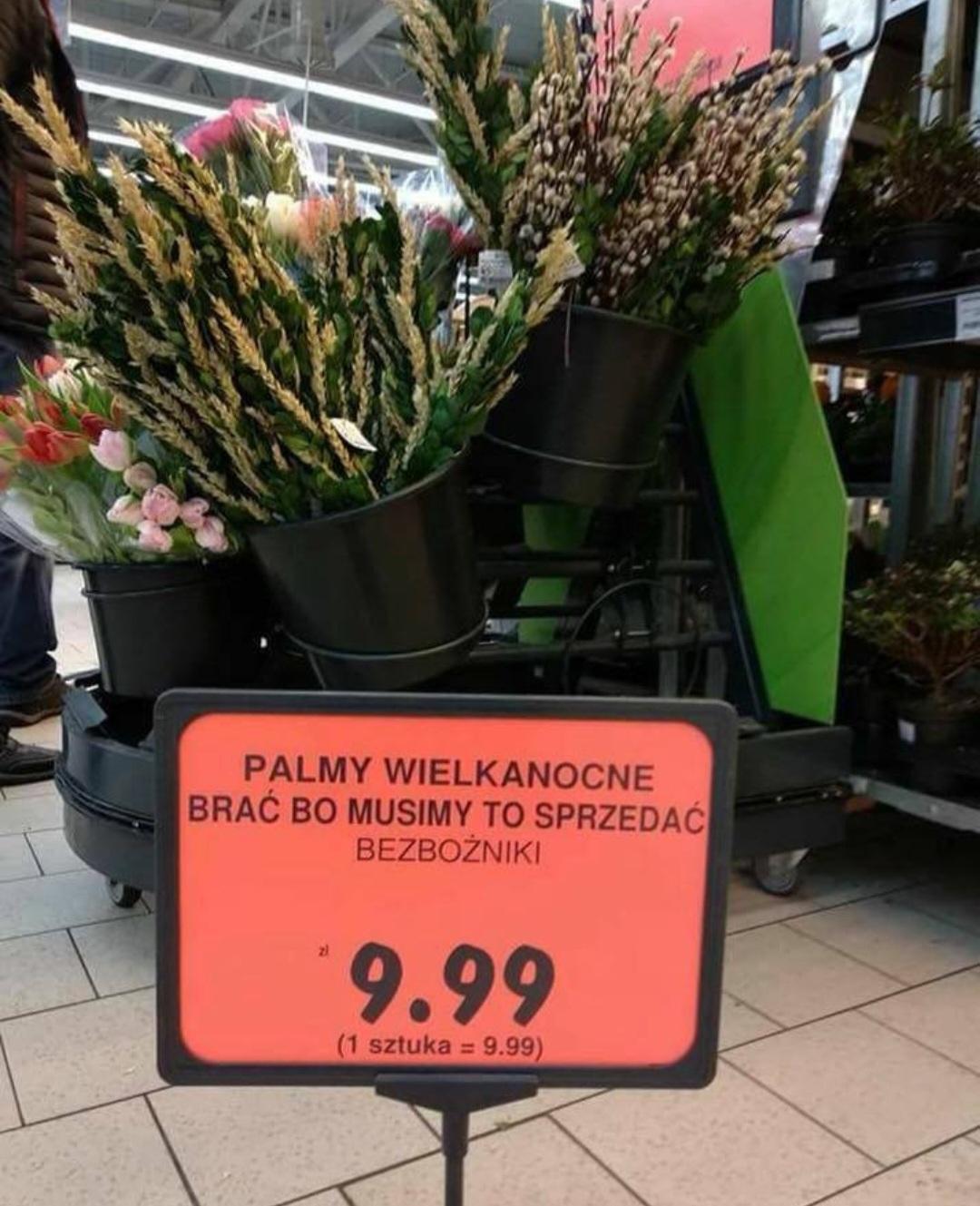 Palmy wielkanocne w sklepie.
Napis na cenówce: "PALMY WIELKANOCNE
BRAĆ BO MUSIMY TO SPRZEDAĆ
BEZBOŻNIKI
9.99
(1 sztuka = 9.99)